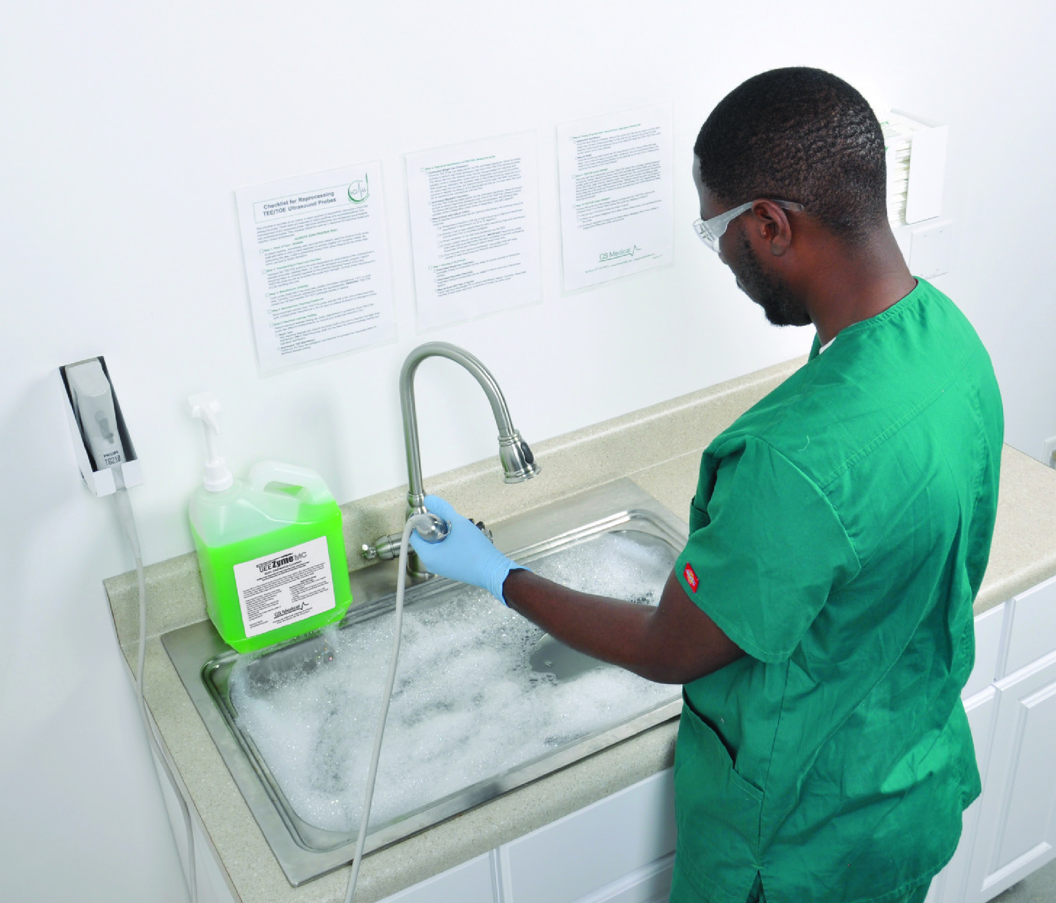 Manual cleaning of a transvaginal probe using an enzymatic cleaner per manufacturer’s recommendation